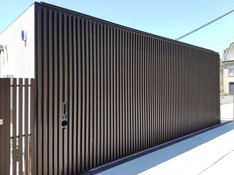 Sectional Overhead Door anodised aluminium vertcal battens aligned fixed head and side panels